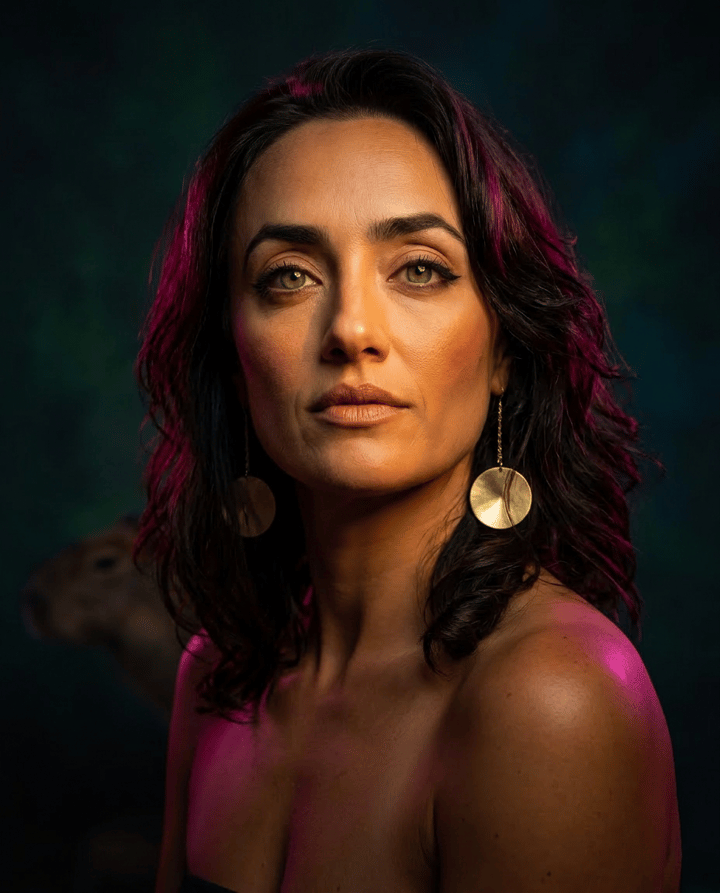 AI-generated bold creative editorial portrait of a consistent character with gel lighting